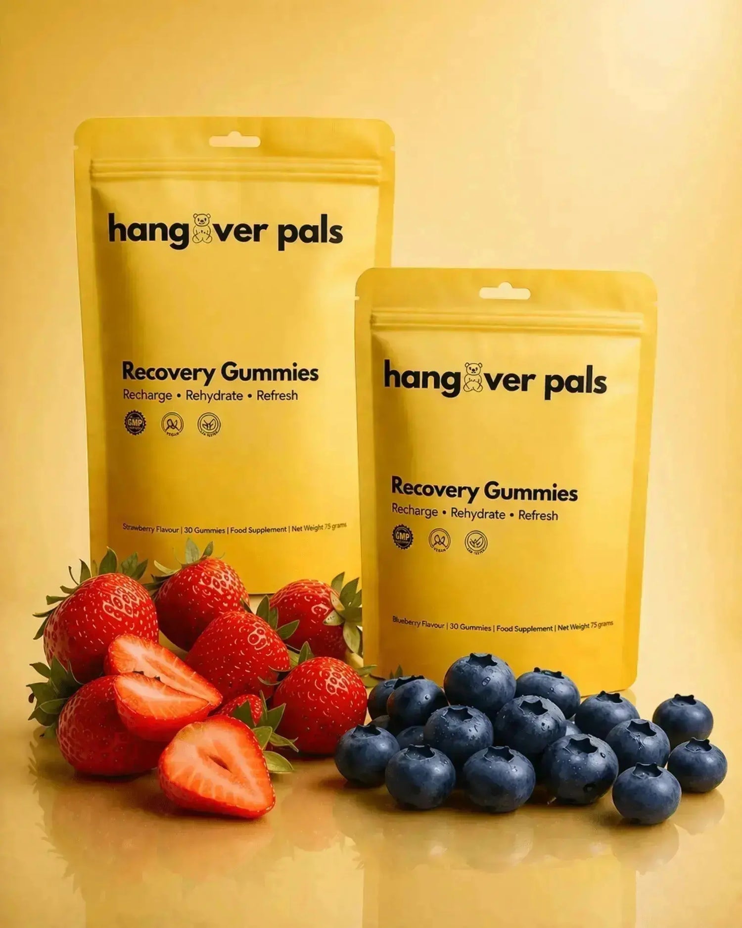 Hangover Pals Recovery Gummies in Strawberry Splash and Blueberry Burst pouches with strawberries and blueberries
